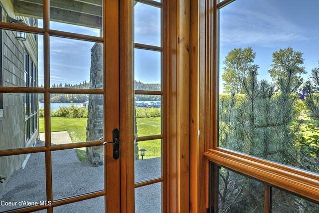 doorway with a water view and french doors