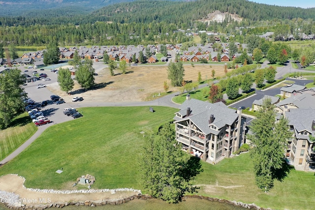 bird's eye view featuring a residential view and a wooded view