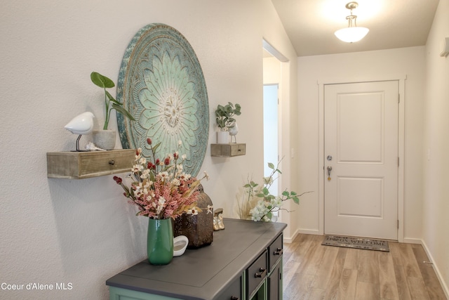 entrance foyer with light wood finished floors and baseboards