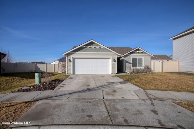 view of front facade with a garage, a front yard, driveway, and fence