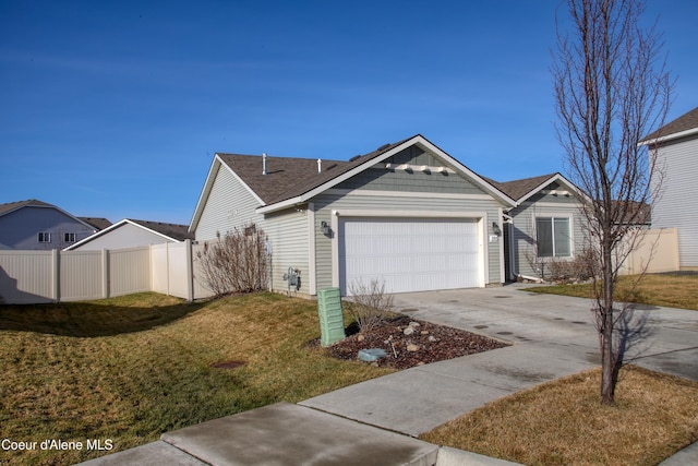 view of front of house featuring an attached garage, concrete driveway, a front yard, and fence