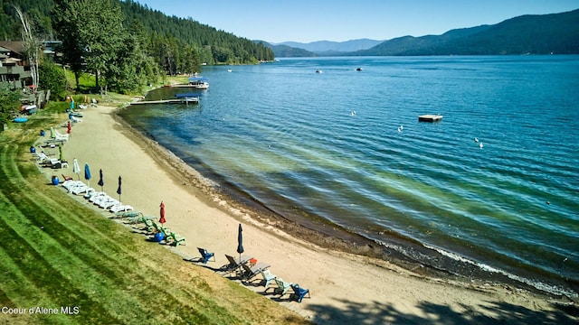 water view featuring a mountain view and a beach view