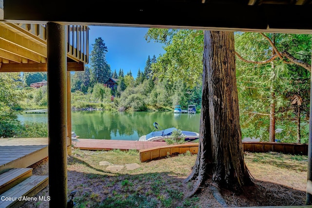 exterior space with a dock and a water view