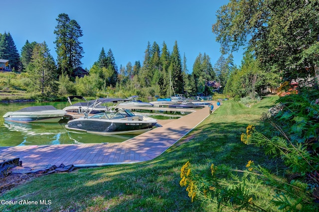 view of home's community featuring a water view and a lawn