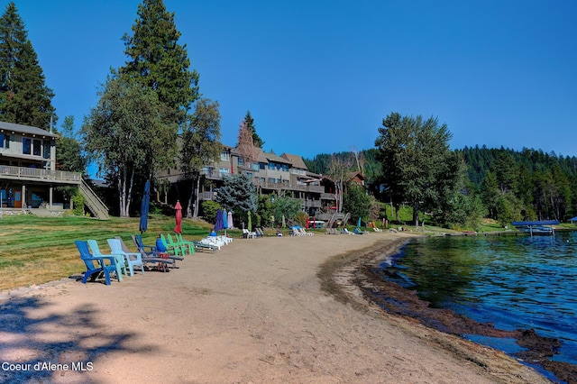 view of property's community with a water view and a yard