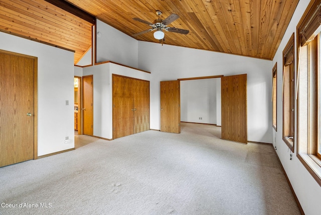 unfurnished bedroom featuring light carpet, high vaulted ceiling, wood ceiling, and baseboards