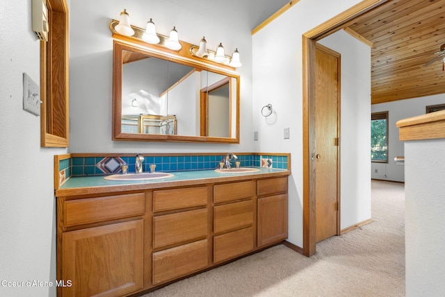 bathroom with double vanity, decorative backsplash, a sink, and carpet flooring