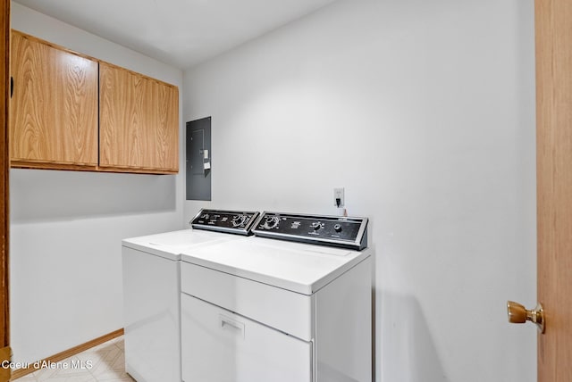 laundry area with baseboards, independent washer and dryer, cabinet space, and electric panel