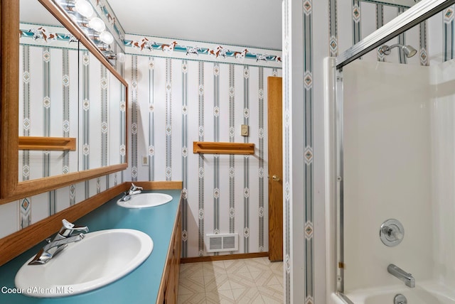 full bathroom with  shower combination, visible vents, a sink, and wallpapered walls