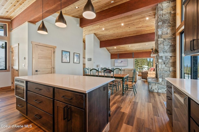 kitchen featuring dark wood finished floors, wooden ceiling, light countertops, and beamed ceiling