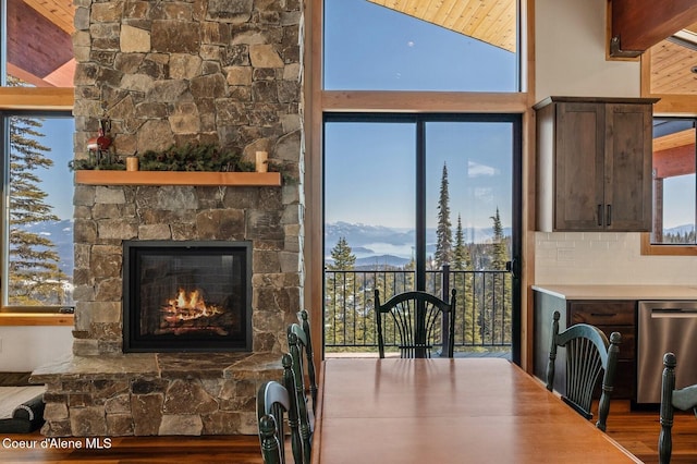 dining space with a fireplace and wood finished floors