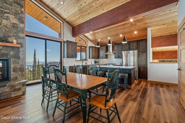 dining room featuring high vaulted ceiling, a stone fireplace, wooden ceiling, dark wood-type flooring, and beam ceiling