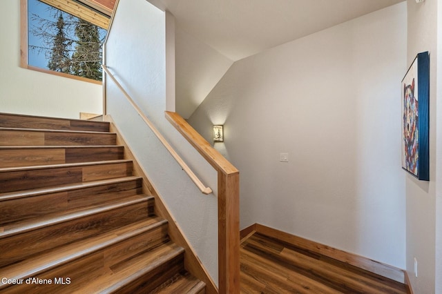 stairway with baseboards and wood finished floors