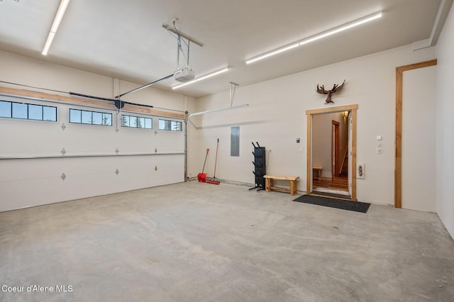 garage featuring a garage door opener and electric panel