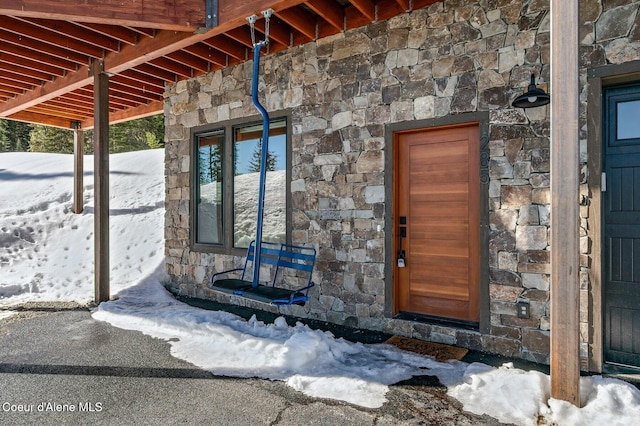 view of exterior entry featuring stone siding