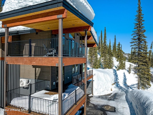 view of snow covered exterior featuring ac unit