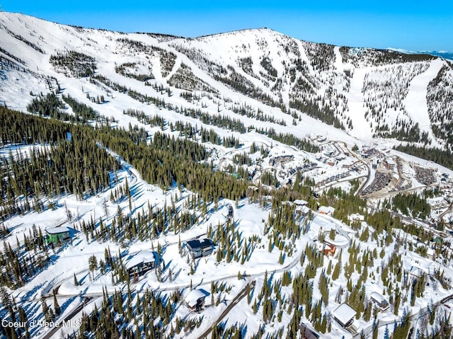 snowy aerial view with a mountain view