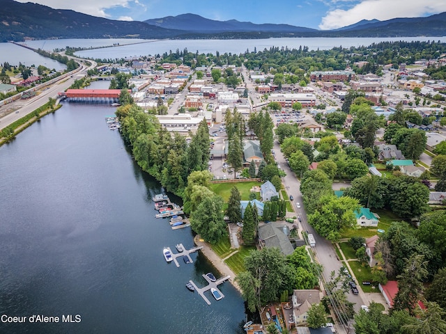 drone / aerial view featuring a water and mountain view