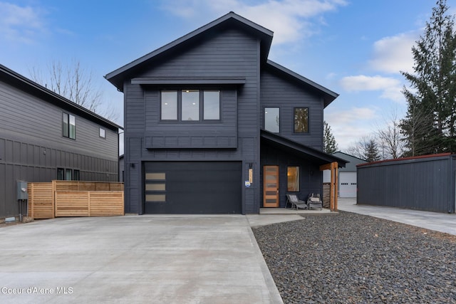 contemporary house with concrete driveway and an attached garage