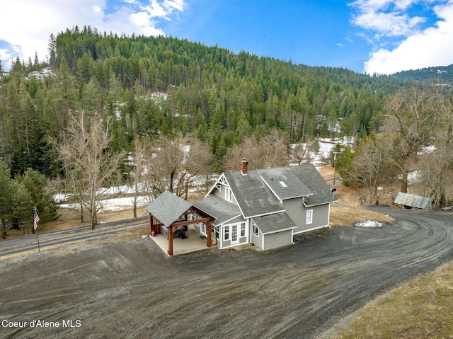 birds eye view of property with a wooded view