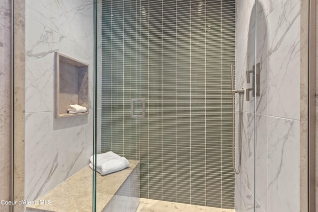 full bath featuring a marble finish shower