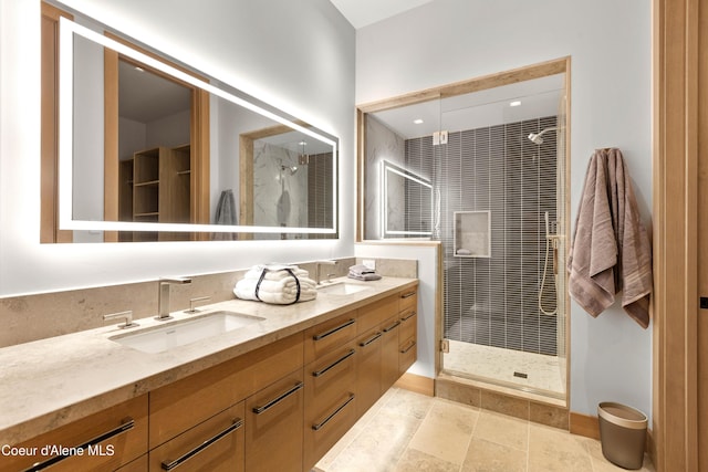 full bathroom with double vanity, a sink, and a shower stall