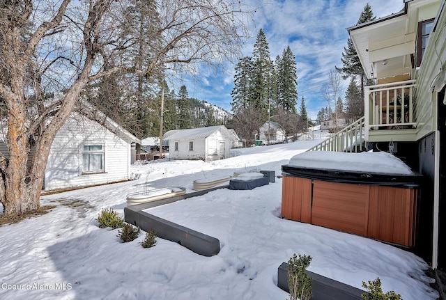 315 Montana St, Mullan, ID 83846 - yard layered in snow featuring stairway, an outdoor structure, and a hot tub