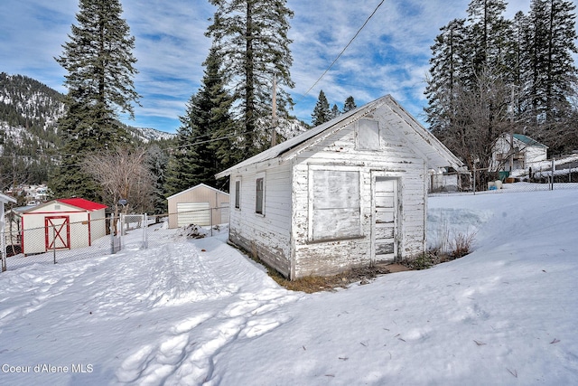 315 Montana St, Mullan, ID 83846 - snow covered structure with an outdoor structure and fence