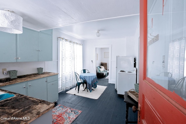 315 Montana St, Mullan, ID 83846 - kitchen with dark wood finished floors, washer / dryer, and blue cabinets