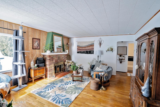 315 Montana St, Mullan, ID 83846 - living area with a brick fireplace, wood walls, and wood finished floors