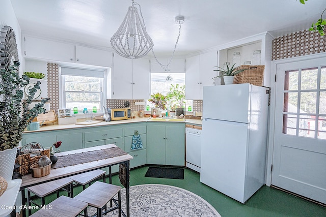 315 Montana St, Mullan, ID 83846 - kitchen with light countertops, white appliances, a sink, and decorative backsplash