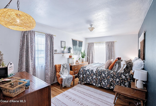 315 Montana St, Mullan, ID 83846 - bedroom featuring light wood-style flooring and a textured ceiling