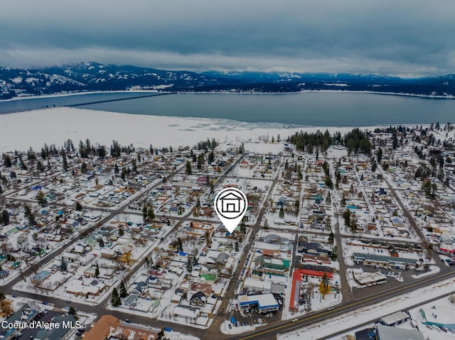 drone / aerial view with a water and mountain view