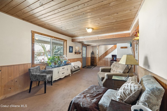 living area with wainscoting, wood ceiling, and wooden walls