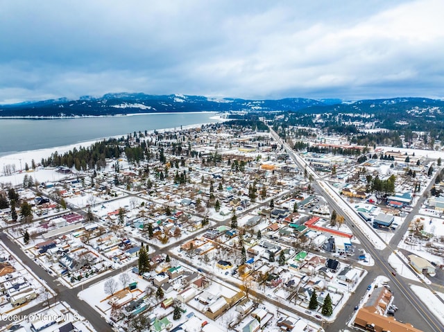 drone / aerial view featuring a water and mountain view