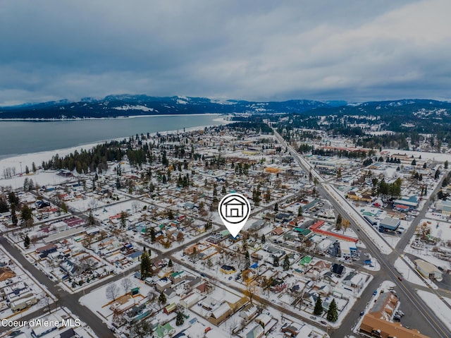 birds eye view of property with a water and mountain view