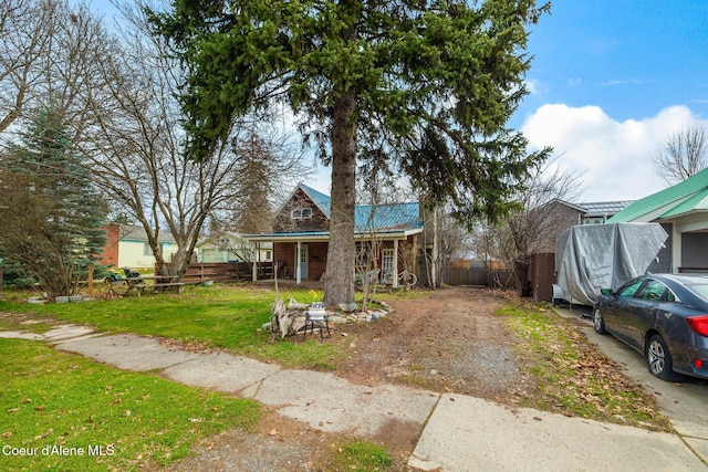 329 S Florence Ave, Sandpoint, ID 83864 - view of front of property featuring metal roof, a porch, a front lawn, and fence