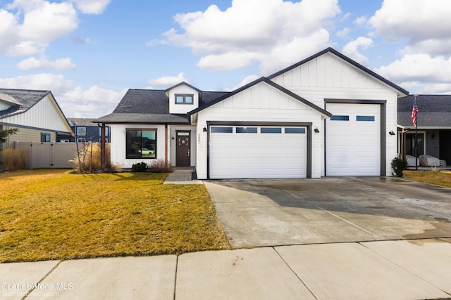 modern farmhouse style home featuring driveway, an attached garage, fence, board and batten siding, and a front yard