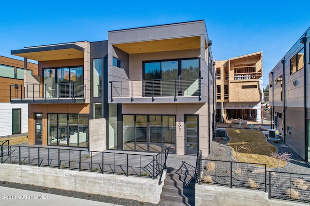 exterior space with central AC unit and stucco siding