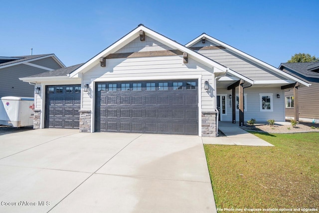 1133 W Cordgrass Ave, Post Falls, ID 83854 - craftsman inspired home with driveway, stone siding, a front lawn, and an attached garage