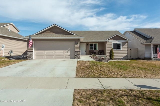 single story home featuring a garage, concrete driveway, stone siding, and a front yard