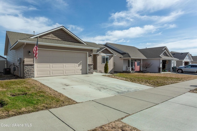 ranch-style house featuring a garage, central AC, stone siding, concrete driveway, and a front yard