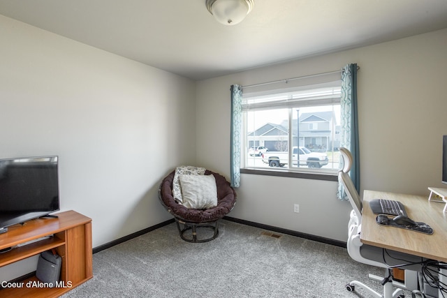 carpeted home office featuring baseboards