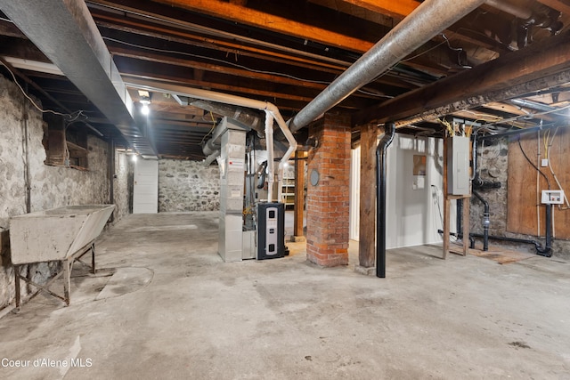 unfinished basement featuring heating unit and electric panel