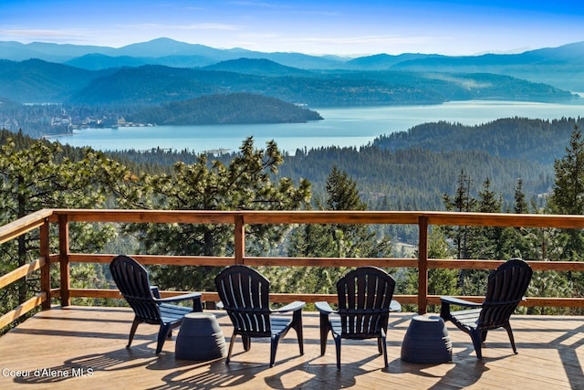 deck with a water and mountain view