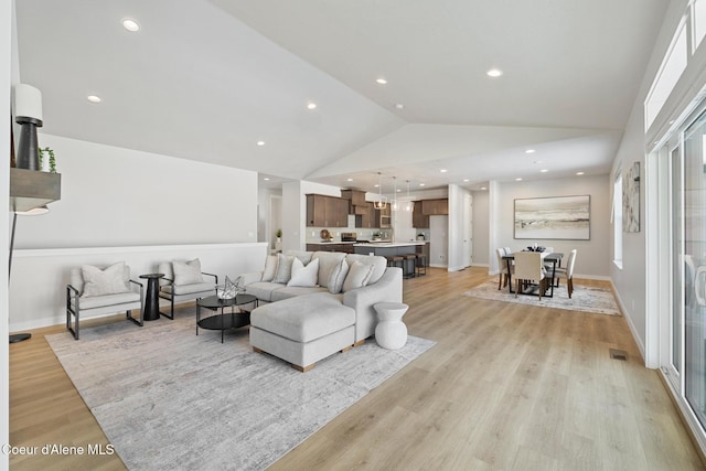 living area with recessed lighting, light wood-style flooring, and baseboards