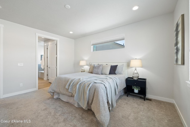 bedroom with ensuite bath, carpet, baseboards, and recessed lighting