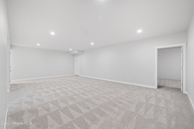 carpeted empty room featuring baseboards and recessed lighting