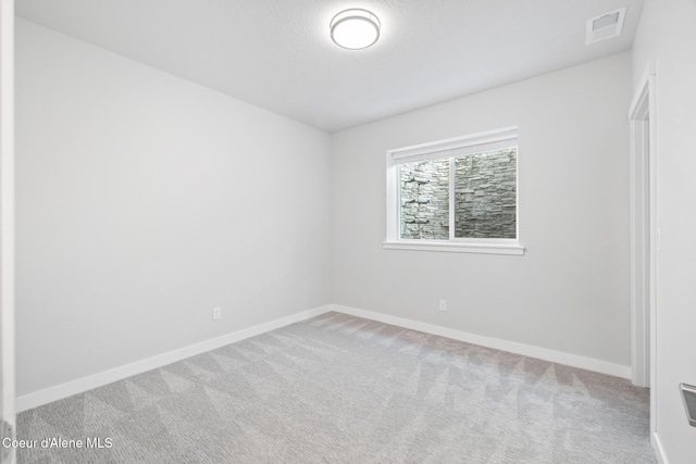 unfurnished bedroom with carpet flooring, visible vents, and baseboards