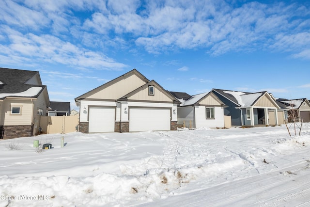 view of front of property with a garage, fence, stone siding, a residential view, and board and batten siding